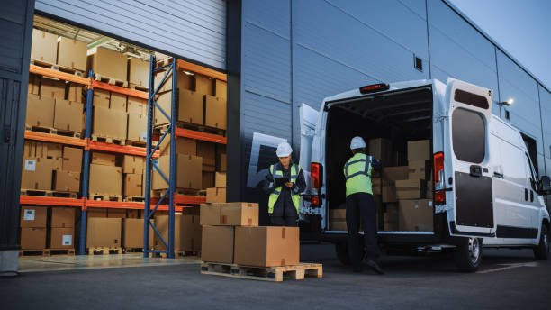 Delivery team loading parcels into a van